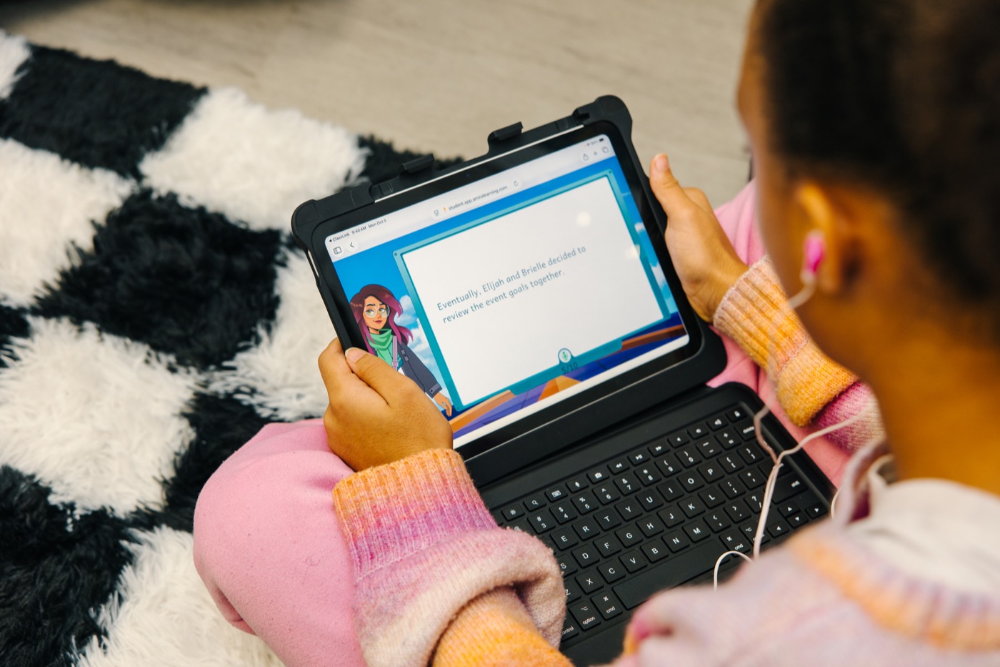 A student using Amira on a laptop, viewed over their shoulder